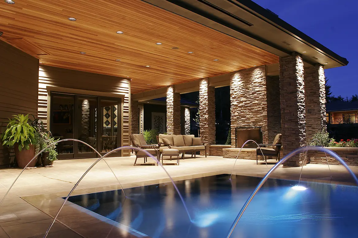 Back patio area featuring a pool with fountains